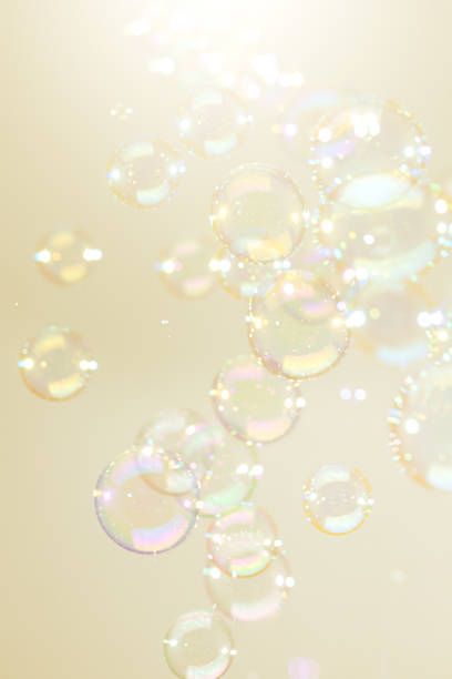 istock Beautiful Transparent Shiny Soap Bubbles Floating on Yellow Background 1360130739