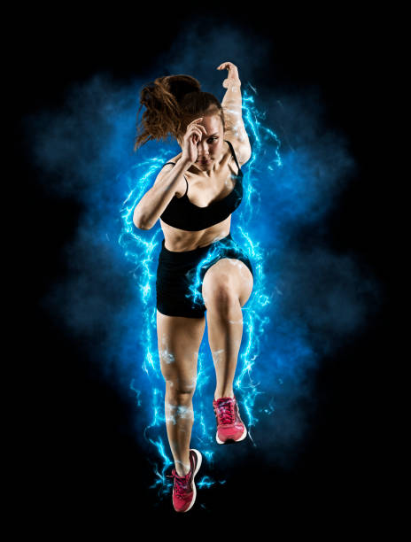 istock Woman sprinter leaving starting blocks on the athletic track 1360131408