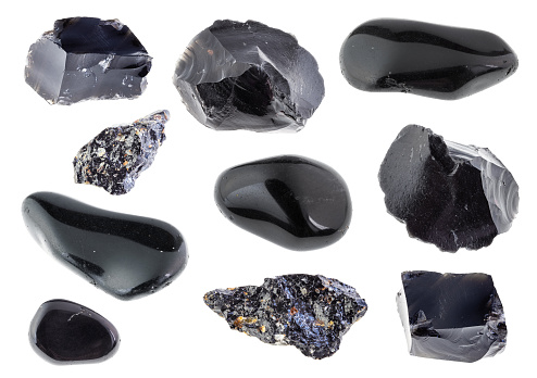 set of various black obsidian stones cutout on white background