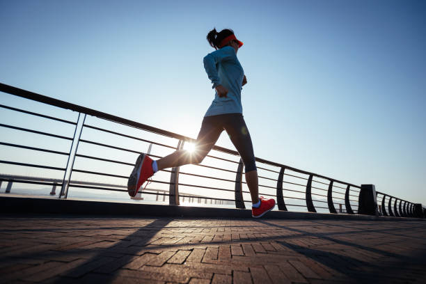 Fitness woman runner running on seaside bridge Fitness woman runner running on seaside bridge Jogging stock pictures, royalty-free photos & images