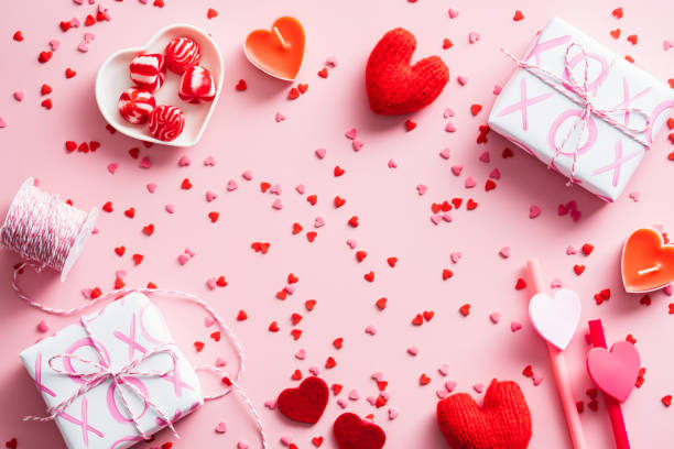 istock Happy Valentines Day composition. Flat lay gift boxes, red hearts, candles, confetti on pink background. Love, romance concept. 1360134683