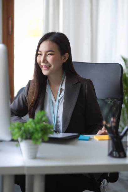 Beautiful business woman sitting in the office using a desktop computer