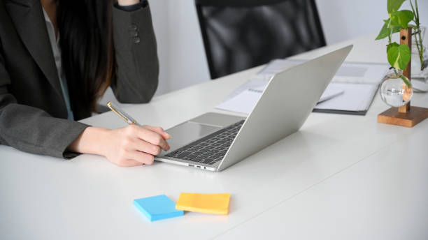 istock Business woman working on portable laptop computer 1360135762
