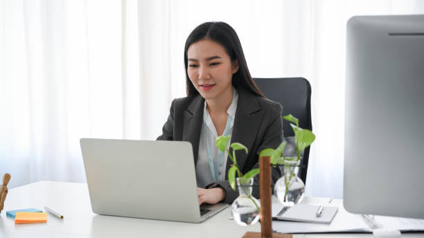 istock Business woman checking her email on laptop computer 1360135767