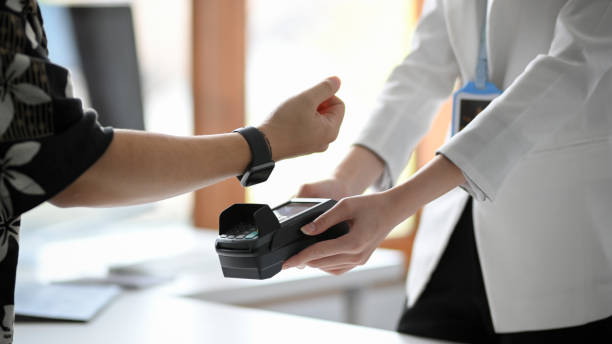 istock a man using his modern digital wristwatch paying his shopping. 1360135784