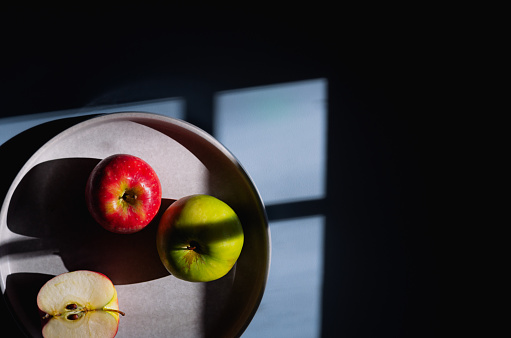 Apples and shadows on a blue background.