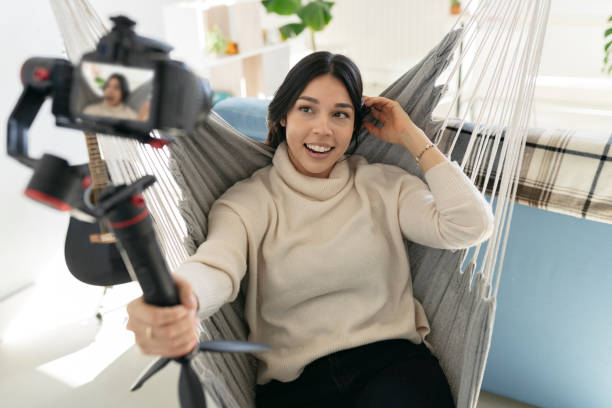 istock pretty hispanic woman makes a videoblog from home 1360136860