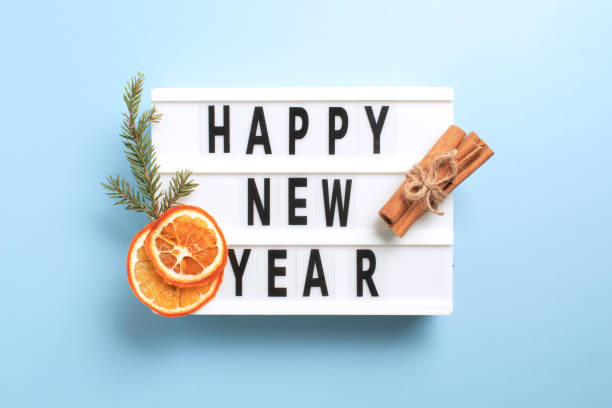 istock Happy New Year text on white Lightbox on blue background. Flat lay, top view, copy space. Festive winter time 1360138121