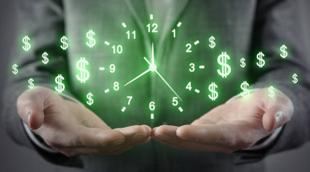Man holding clock and dollar symbols. Time is money Man holding clock and dollar symbols. Time is money time as currency stock pictures, royalty-free photos & images