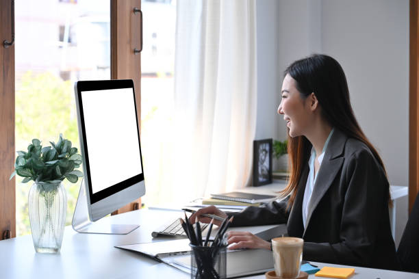 istock Side view businesswoman checking financial data on computer. 1360139144