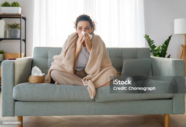 Girl Is Holding Paper Tissue And Blowing Nose Stock Photo - Download Image Now - Cold And Flu, Illness, Coughing
