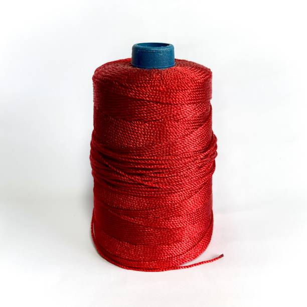 istock Spool of red yarn for knitwork 1360141200