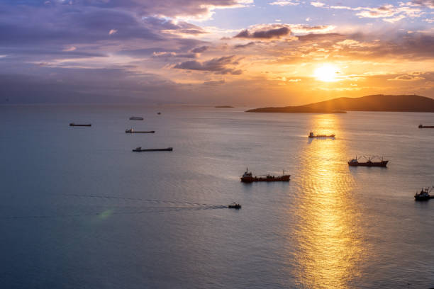 istock Container ships cargo freighter shipping moored in sea port at sunset 1360142268