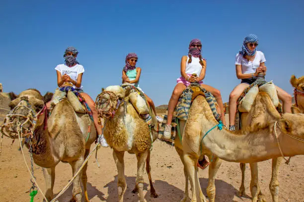 Photo of Girls riding camel in the Egyptian desert