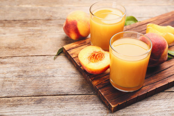 natural peach juice and fresh fruits on wooden table. space for text - peach juice imagens e fotografias de stock