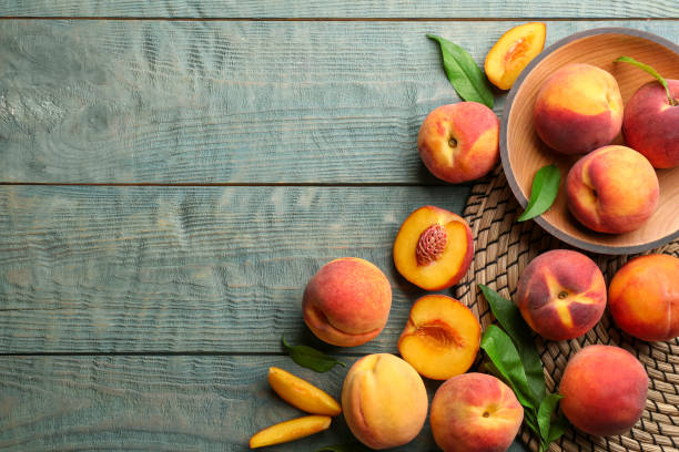 istock Fresh sweet peaches on wooden table, flat lay. Space for text 1360145135