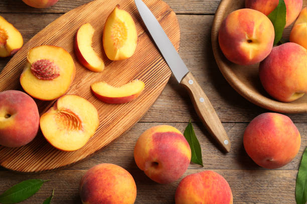 istock Flat lay composition with fresh sweet peaches on wooden table 1360146033