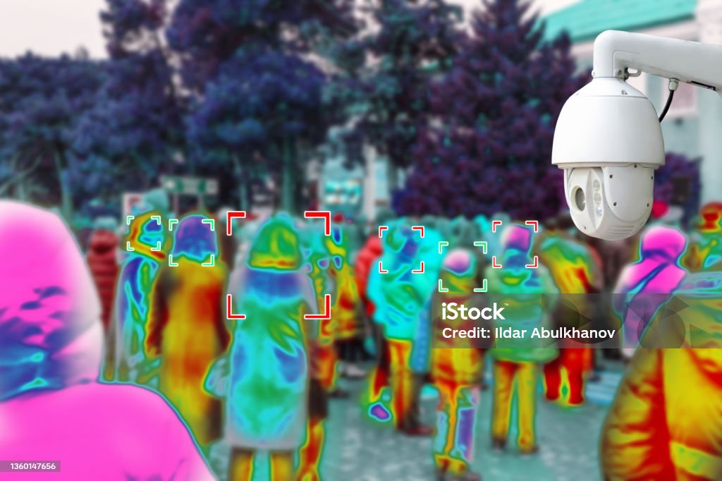 CCTV. The surveillance camera takes pictures in public places, with people in the background blurring with colorful identification. Concept of modern technologies and security CCTV. The surveillance camera takes pictures in public places, with people in the background blurring with colorful identification. Concept of modern technologies and security. Infrared Stock Photo