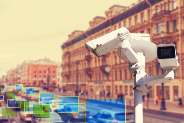istock The concept of video surveillance and security technologies. Video surveillance camera on the background of the city road with cars. Definition zone 1360147679