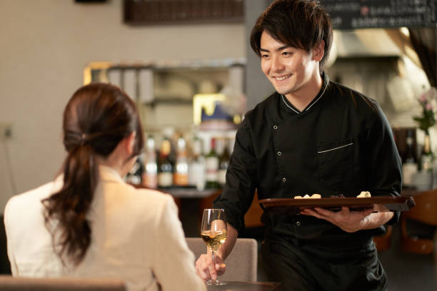 istock Asian man taking an order at a restaurant 1360148636