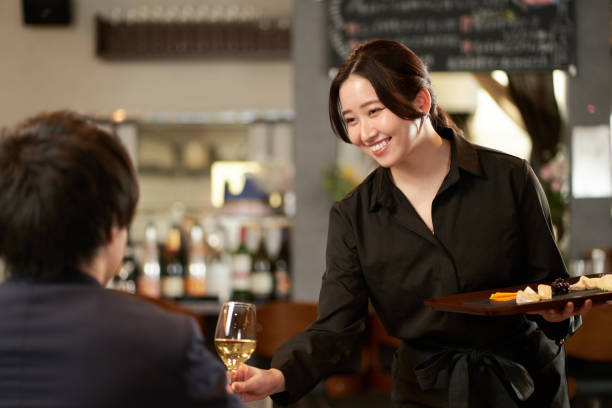 asian female servicing at a restaurant - café edifício de restauração imagens e fotografias de stock