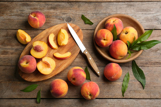 istock Flat lay composition with fresh sweet peaches on wooden table 1360148650