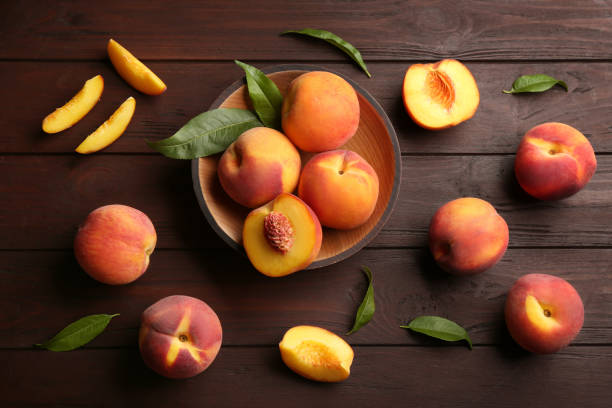 istock Fresh sweet peaches on wooden table, flat lay 1360148694