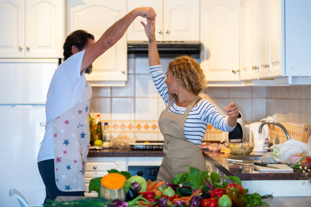 istock Rear View Of People Preparing Food In Kitchen 1360149314