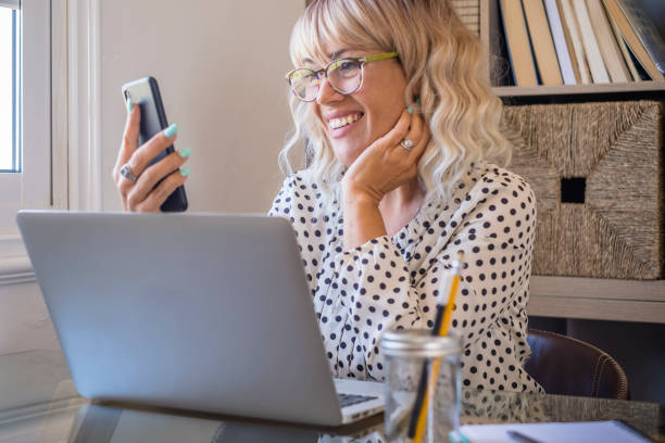 istock Mid Adult Woman Using Mobile Phone 1360149345