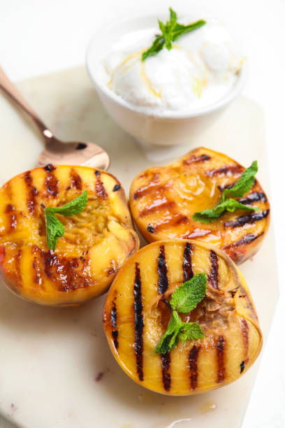 istock Delicious grilled peaches with honey and mint on board, closeup 1360149866
