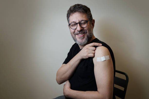 istock Vaccinated man showing the arm with the bandage 1360150840