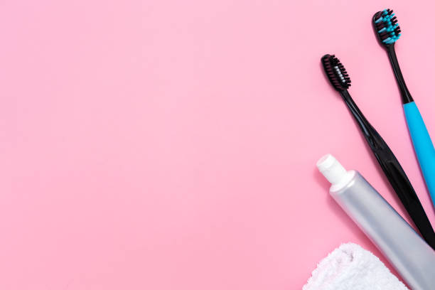 istock Toothbrushes, toothpaste, towel on pink background. Flat lay. Copy space. The concept of oral hygiene 1360150841