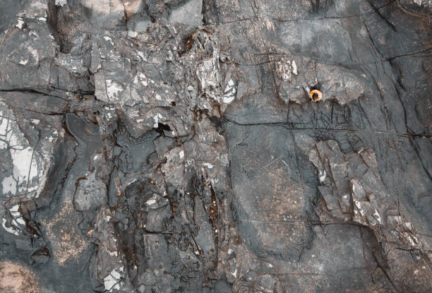 istock Man in sport clothes sitting on stone texture from aerial view 1360151191