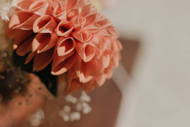 istock Large orange flower in a wedding bouquet. Selective focus and blurred background. 1360151911