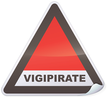 Vigipirate danger sticker (state of anti-terrorist alert in France) triangular with a fold on a white background