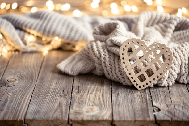 istock Cozy background with a knitted element, decorative heart and bokeh lights. 1360155761