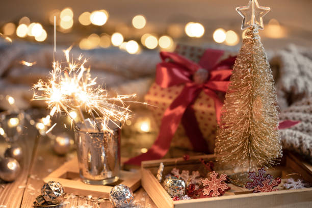 istock Cozy Christmas background with glowing sparklers and decor details. 1360155762