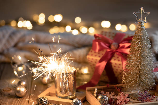 istock Cozy Christmas background with glowing sparklers and decor details. 1360155768