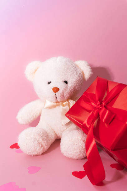 istock Cute white bear toy with red box on light pink background, space for text. Valentine's day celebration 1360155772