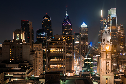 Aerial panoramic cityscape of Philadelphia financial downtown, Pennsylvania, USA. Philadelphia City Hall Clock Tower at summer night time. A vibrant business and cultural neighborhoods.