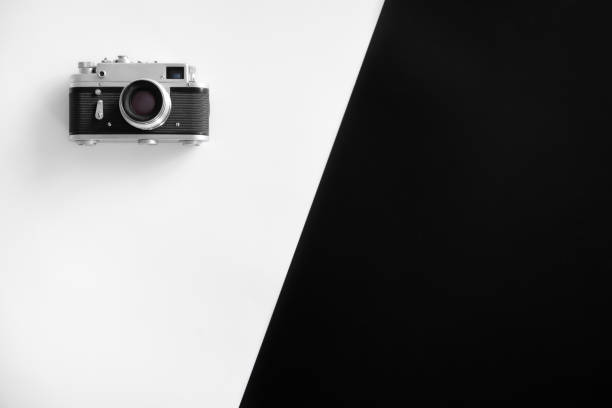 istock Vintage retro camera on black and white background, flat lay. 1360156876