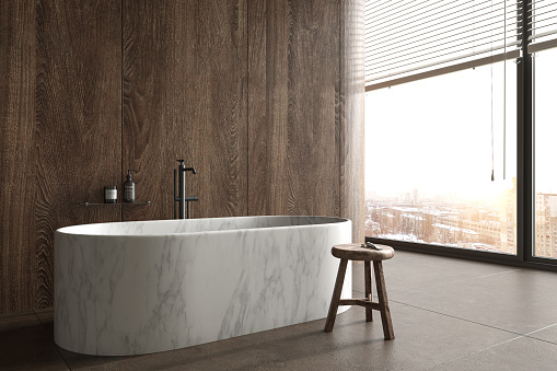 Minimal luxury bathroom with city view. Stone floor, wood tile wall and modern marble bathtub. Interior have large windows. 3d render illustration.