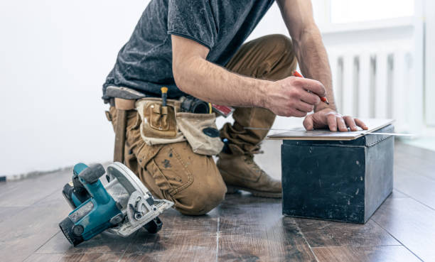 istock A male worker puts laminate flooring on the floor. 1360157035