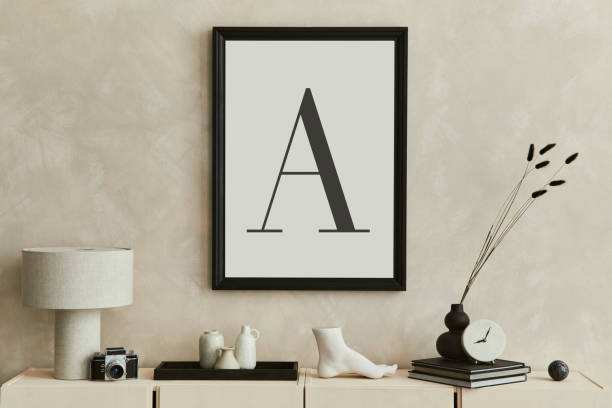 istock Creative composition of modern beige living room interior design with designed sculpture, mock up poster frame, beige wooden sideboard and personal accessories. Template. 1360158999