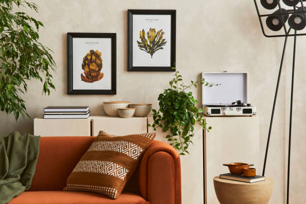 istock Creative interior composition of living room with designed couch, two mock up poster frames, coffee table, palnts, industrial lamp and personal accessoriers. Template. 1360163395