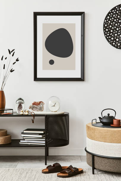 istock Stylish living room interior composition with mock up poster frame, pouf, console and elegant personal accessories. Copy sapce. Template.