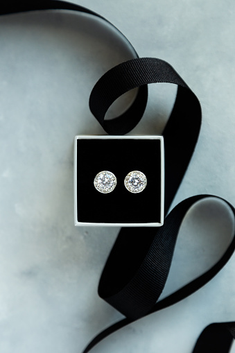 photography showing diamond earrings in a box