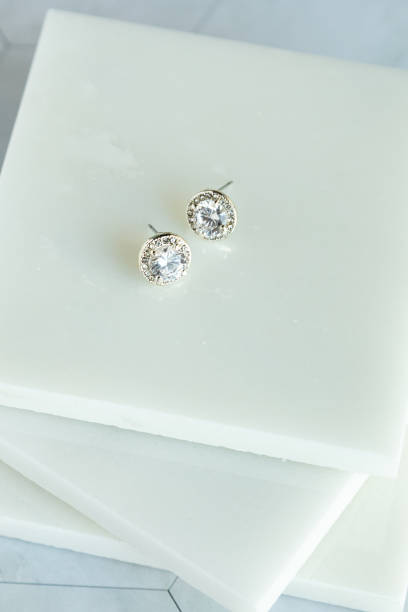 Set of diamond earrings set of Diamond earrings photographed in white marble diamond earring stock pictures, royalty-free photos & images