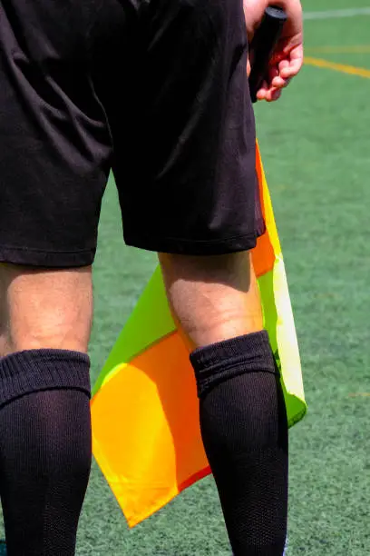 Assistant football referee and referee's flag during a futbol match