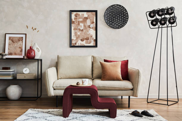 istock Elegant living room interior composition with beige sofa, black console, coffee table, mock up poster frame and creative design personal accessories. Copy space. Template.